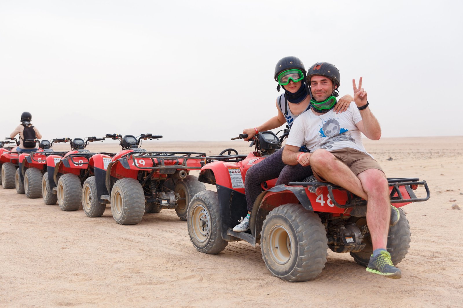 HURGHADA, EGYPT - MAY 18, 2015: Young couple riding sand ATV and having fun