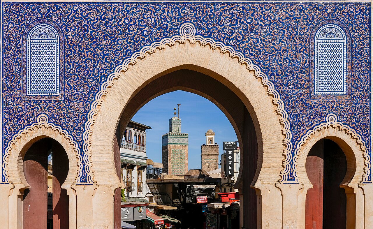Bab Bou Jeloud framing minaret of Bou Inania Madrasa, Fes, Morocco